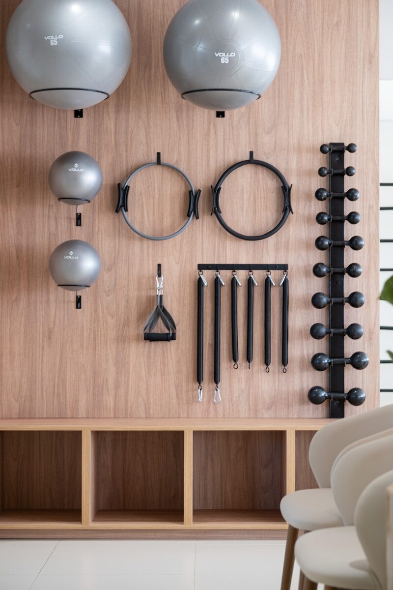 Gym equipment neatly organized on a wooden wall.